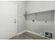 Laundry room with laminate flooring, a shelf, and washer/dryer hookups at 9224 W Raymond St, Tolleson, AZ 85353
