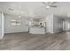 Spacious living room with light gray walls and wood laminate flooring throughout at 9224 W Raymond St, Tolleson, AZ 85353