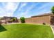 Wide shot of the backyard with artificial turf, outdoor kitchen, and pergola covered dining at 9448 W Villa Hermosa --, Peoria, AZ 85383
