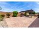 Expansive backyard with a pergola-covered dining area, landscaping, and brick-paved ground at 9448 W Villa Hermosa --, Peoria, AZ 85383