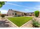 Beautiful backyard featuring artificial turf, a built-in grill, and a covered patio with outdoor seating at 9448 W Villa Hermosa --, Peoria, AZ 85383