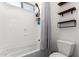 Clean bathroom design showcasing a bathtub with shower, tiled walls, and contemporary shelving at 9448 W Villa Hermosa --, Peoria, AZ 85383