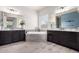 Dual sink vanities flank a jetted tub in this bathroom with stylish neutral colors and finishes at 9448 W Villa Hermosa --, Peoria, AZ 85383