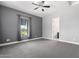 Spacious bedroom with gray walls, plush carpet, and a decorative ceiling fan fixture at 9448 W Villa Hermosa --, Peoria, AZ 85383