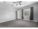 Neutral bedroom with a ceiling fan, large window with blinds, and light gray walls at 9448 W Villa Hermosa --, Peoria, AZ 85383