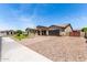 Charming single-story home with desert landscaping, a driveway, and an attached garage at 9448 W Villa Hermosa --, Peoria, AZ 85383
