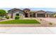 Well-manicured front yard with artificial turf, desert landscaping, and stone accents on the facade at 9448 W Villa Hermosa --, Peoria, AZ 85383