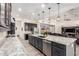 Open kitchen boasts a large island, dark cabinets, granite counters, stainless appliances, and recessed lighting at 9448 W Villa Hermosa --, Peoria, AZ 85383