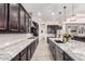 Spacious kitchen featuring dark cabinets, granite countertops, stainless steel appliances, and recessed lighting at 9448 W Villa Hermosa --, Peoria, AZ 85383