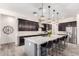 Modern kitchen with a large island, stainless steel appliances, dark cabinets, and stylish pendant lighting at 9448 W Villa Hermosa --, Peoria, AZ 85383