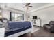 The main bedroom has wood floors, a white bed frame, tray ceilings, and large windows with plantation shutters at 9448 W Villa Hermosa --, Peoria, AZ 85383