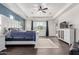 Bright primary bedroom showcasing wood floors, a white bed frame, blue accent wall, and tray ceiling at 9448 W Villa Hermosa --, Peoria, AZ 85383