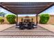 Inviting outdoor patio with a pergola, dining table, and lush landscaping, great for entertaining at 9448 W Villa Hermosa --, Peoria, AZ 85383