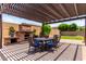 Inviting outdoor patio with a pergola, dining table, and lush landscaping, great for entertaining at 9448 W Villa Hermosa --, Peoria, AZ 85383