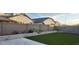 Backyard featuring a turf lawn, concrete fence, and stone-accented planters at 10351 W Deanna Dr, Peoria, AZ 85382