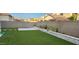 This backyard features an artificial lawn, block wall surrounds, with a patio slab and garden at 10351 W Deanna Dr, Peoria, AZ 85382