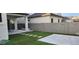 This backyard boasts artificial turf, stone pavers, a block wall, and a covered patio at 10351 W Deanna Dr, Peoria, AZ 85382