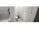 This half bathroom has tiled shower walls, modern toilet, and tiled floors, providing a functional space at 10351 W Deanna Dr, Peoria, AZ 85382