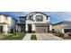 Charming two-story home with a two-car garage, manicured lawn, and modern architectural details at 10351 W Deanna Dr, Peoria, AZ 85382