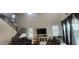 Spacious living room with high ceilings, staircase, plantation shutters, and comfortable leather furniture at 10351 W Deanna Dr, Peoria, AZ 85382