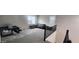 Upstairs loft area features neutral carpet, large window with shutters, and space for relaxation and play at 10351 W Deanna Dr, Peoria, AZ 85382
