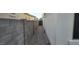 The side yard has a stone paver walkway and a gravel bed between block walls at 10351 W Deanna Dr, Peoria, AZ 85382