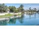 Stunning waterfront view with lush greenery, mature palm trees, and a private dock at 10458 N 101St St, Scottsdale, AZ 85258