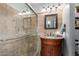 Elegant bathroom showcasing a glass shower, granite countertop, and dark wood vanity with ample lighting at 1214 W Sand Dune Dr, Gilbert, AZ 85233