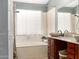 Well-lit bathroom features soaking tub, double vessel sinks, granite countertops, and updated fixtures at 1214 W Sand Dune Dr, Gilbert, AZ 85233