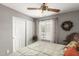 Bright bedroom features a ceiling fan, window shutters, and closet for storage, creating a serene space at 1214 W Sand Dune Dr, Gilbert, AZ 85233