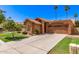 Inviting home exterior with mature landscaping and a spacious driveway at 1214 W Sand Dune Dr, Gilbert, AZ 85233