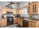 Well-lit kitchen with ample cabinets, stainless steel appliances, and tile flooring at 1214 W Sand Dune Dr, Gilbert, AZ 85233
