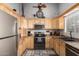 Well-lit kitchen with ample cabinets, stainless steel appliances, and tile flooring at 1214 W Sand Dune Dr, Gilbert, AZ 85233