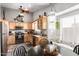 Cozy eat-in kitchen with oak cabinets, black appliances, and a window seat for casual dining at 1214 W Sand Dune Dr, Gilbert, AZ 85233