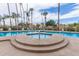 Community pool and spa surrounded by palm trees and well-maintained landscaping at 1214 W Sand Dune Dr, Gilbert, AZ 85233