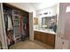 Bathroom boasts double sinks, wood cabinets, and an open closet with ample storage at 1219 E Avenida Isabela --, Casa Grande, AZ 85122