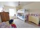 Bedroom features a bunk bed, window bench, and neutral carpet at 1219 E Avenida Isabela --, Casa Grande, AZ 85122