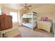 Bright bedroom featuring a white bunk bed, ceiling fan, and neutral walls for a cozy atmosphere at 1219 E Avenida Isabela --, Casa Grande, AZ 85122