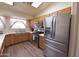 Modern kitchen featuring stainless steel appliances, wooden cabinets, and a bright atmosphere at 1219 E Avenida Isabela --, Casa Grande, AZ 85122