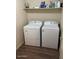 Functional laundry room with a washer, dryer, and overhead shelving at 1219 E Avenida Isabela --, Casa Grande, AZ 85122