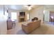 Cozy living room featuring a fireplace, comfortable seating, and ample natural light from the window at 1219 E Avenida Isabela --, Casa Grande, AZ 85122