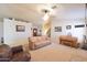 Spacious living area with plush carpeting, a piano, and comfortable leather seating at 1219 E Avenida Isabela --, Casa Grande, AZ 85122