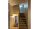 Carpeted staircase with wooden handrail leads to the upper level of this home at 1219 E Avenida Isabela --, Casa Grande, AZ 85122