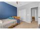 This comfortable bedroom offers a blue accent wall, ceiling fan, and ample natural light at 1405 S Honeysuckle Cir, Gilbert, AZ 85296