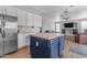 Open kitchen with blue island, stainless refrigerator, and views into the living area at 1405 S Honeysuckle Cir, Gilbert, AZ 85296
