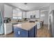 Modern kitchen with white cabinets, stainless appliances, and a contrasting blue island at 1405 S Honeysuckle Cir, Gilbert, AZ 85296