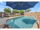 A refreshing private pool under a shade umbrella, perfect for relaxation and outdoor enjoyment at 1405 S Honeysuckle Cir, Gilbert, AZ 85296