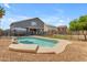 Home's backyard featuring a pool with rock accents at 1405 S Honeysuckle Cir, Gilbert, AZ 85296
