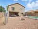 Backyard featuring a patio, fire pit, and gravel landscape, perfect for outdoor living at 14626 N 132Nd Ave, Surprise, AZ 85379