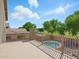 Private balcony offering views of lush greenery, mature landscaping, and the sparkling pool below at 14626 N 132Nd Ave, Surprise, AZ 85379